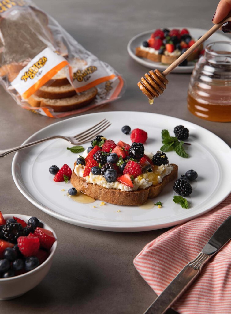 Nature’s Own bread covered with cheese, fruit and drizzled with honey